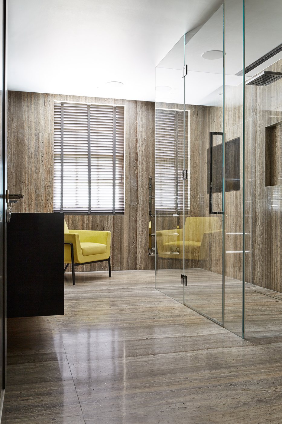 The walk-in shower and dressing area continue the same travertine from floor to ceiling — Avenue Road, Roma Marble