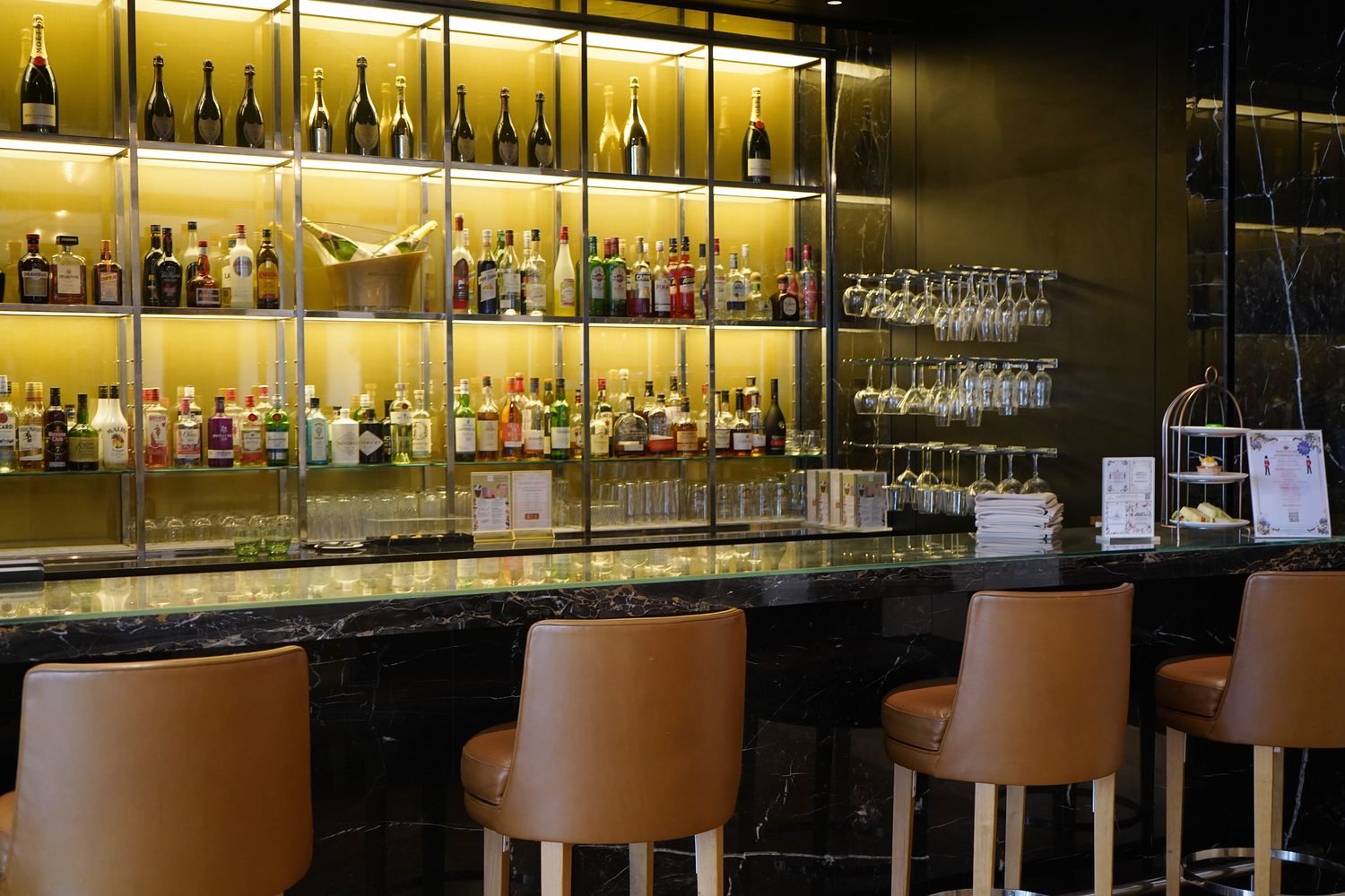 A Portoro Gold marble bar counter with leather stools, Blakemore Hyde Park - Roma Marble
