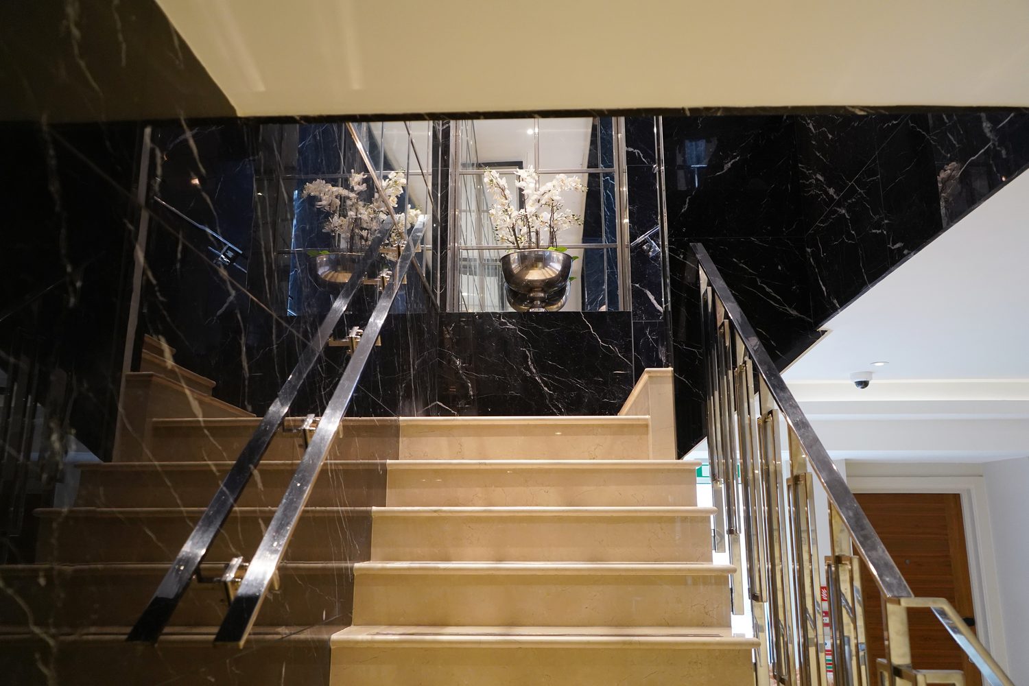 A staircase in Nero Marquina and Crema Marfil marble, Blakemore Hyde Park - Roma Marble