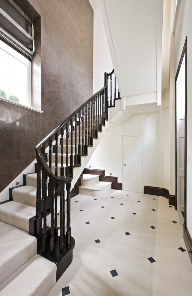 Portland stone flooring accented with Stanhope Black cabochons through the entrance hall — Mayfair, Roma Marble