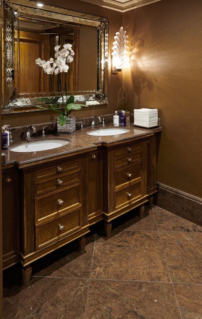 A Red Malibu bathroom, taken from floor to fittings in the one stone — Les Ambassadeurs, Roma Marble