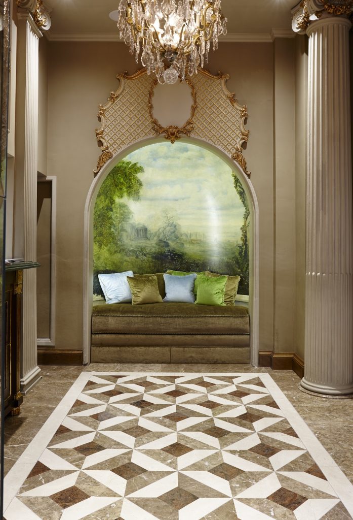 Light Emperador, Dark Emperador and Crema Marfil continue through reception and the bar — Les Ambassadeurs, Roma Marble