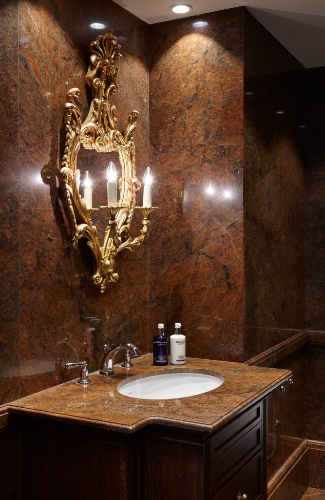 A Red Malibu bathroom, taken from floor to fittings in the one stone — Les Ambassadeurs, Roma Marble
