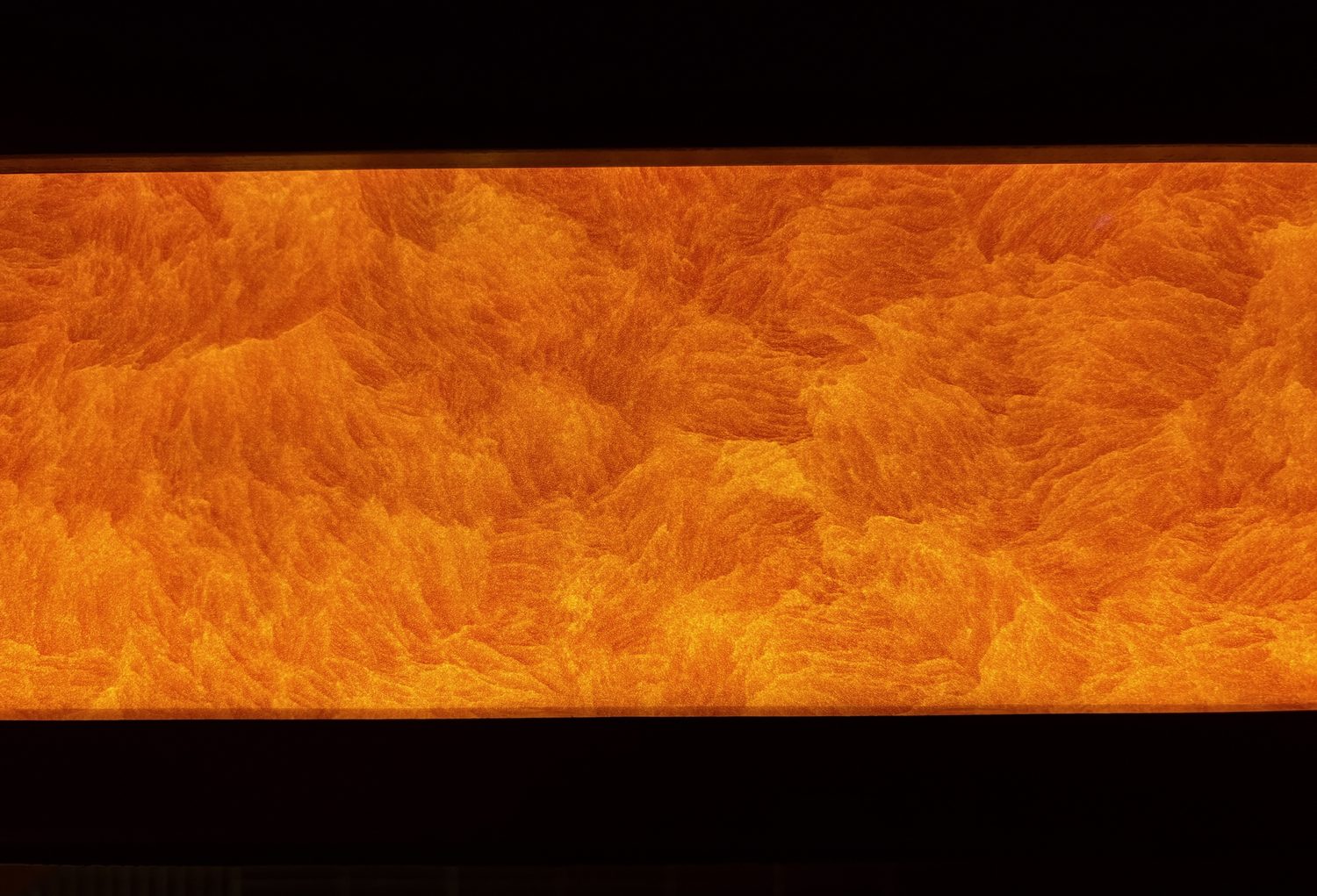 A backlit stone feature panel above the bar at Lucky Cat Bishopsgate - Roma Marble