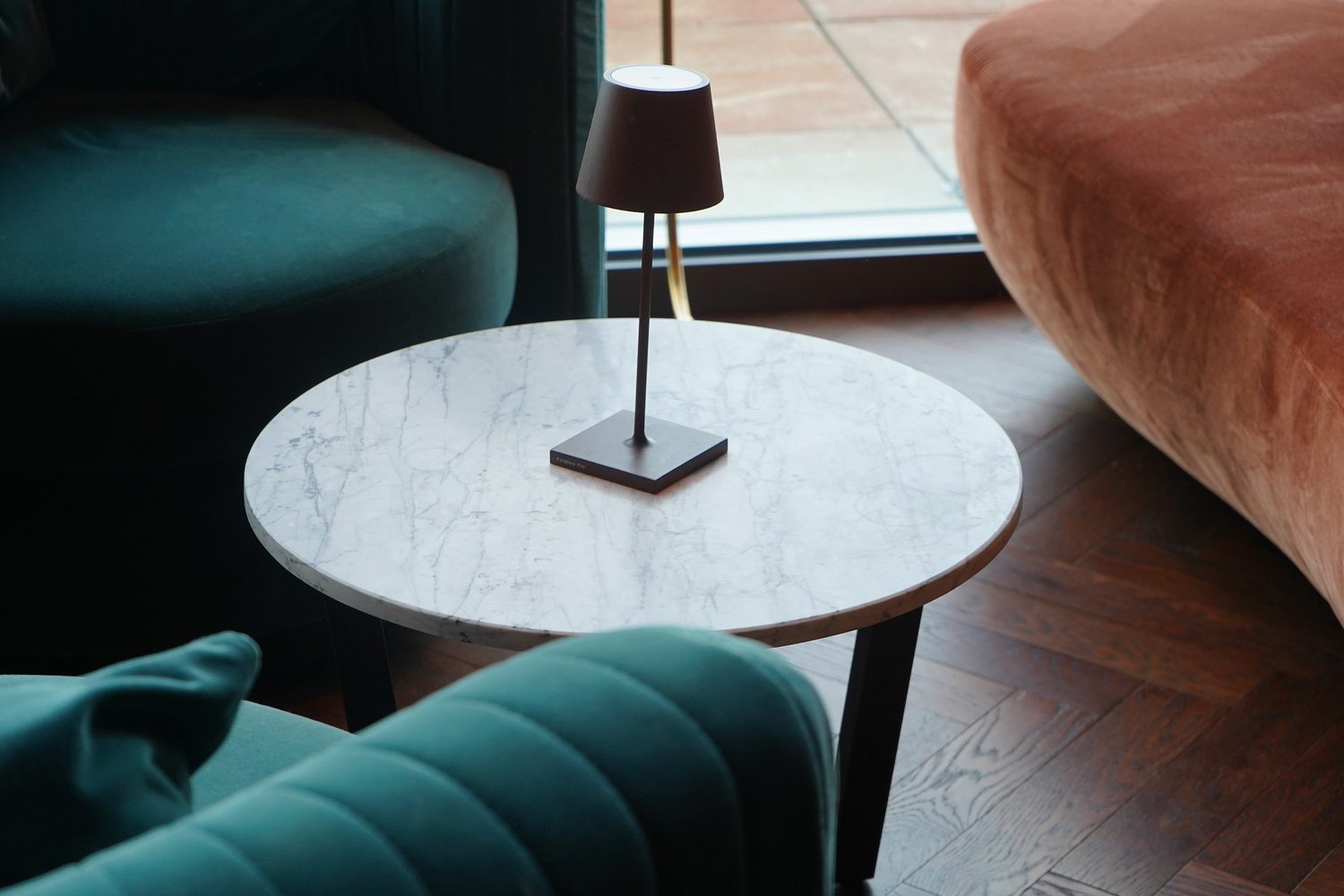 A round Carrara Venatino marble side table at Lucky Cat Bishopsgate - Roma Marble