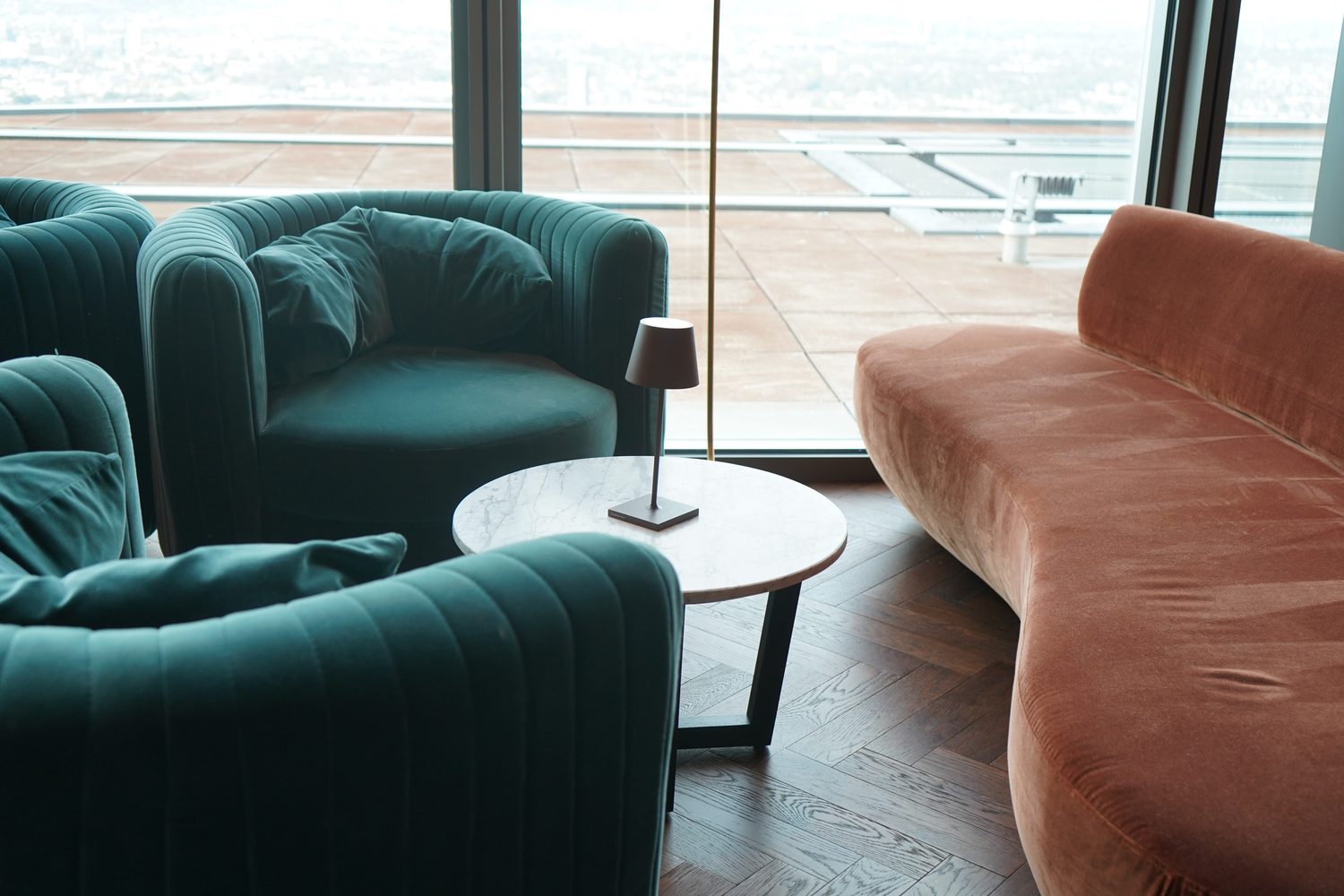Carrara Venatino side tables beside the window seating at Lucky Cat Bishopsgate - Roma Marble