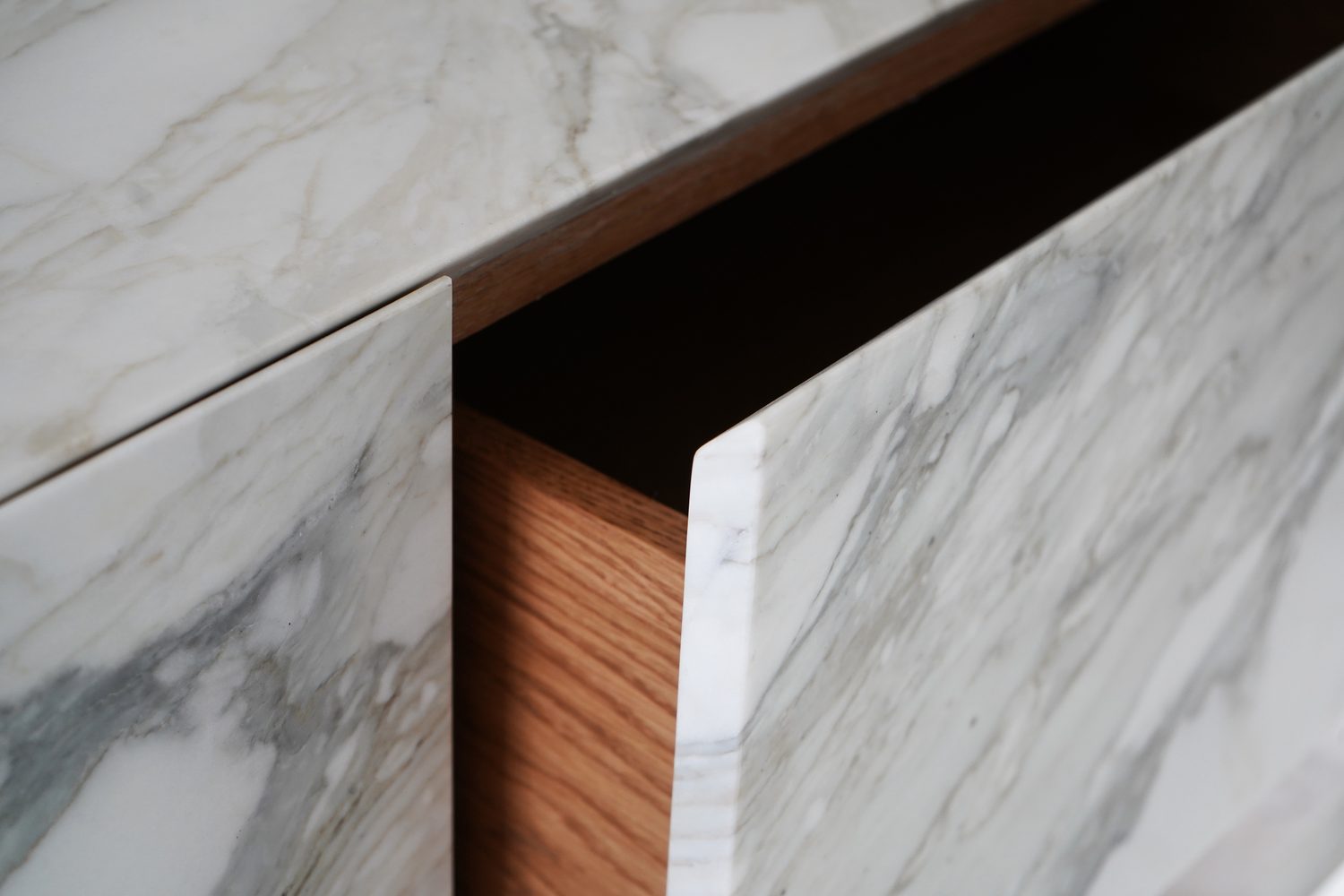 Detail of a mitred Carrara marble edge meeting timber joinery, Oxford - Roma Marble