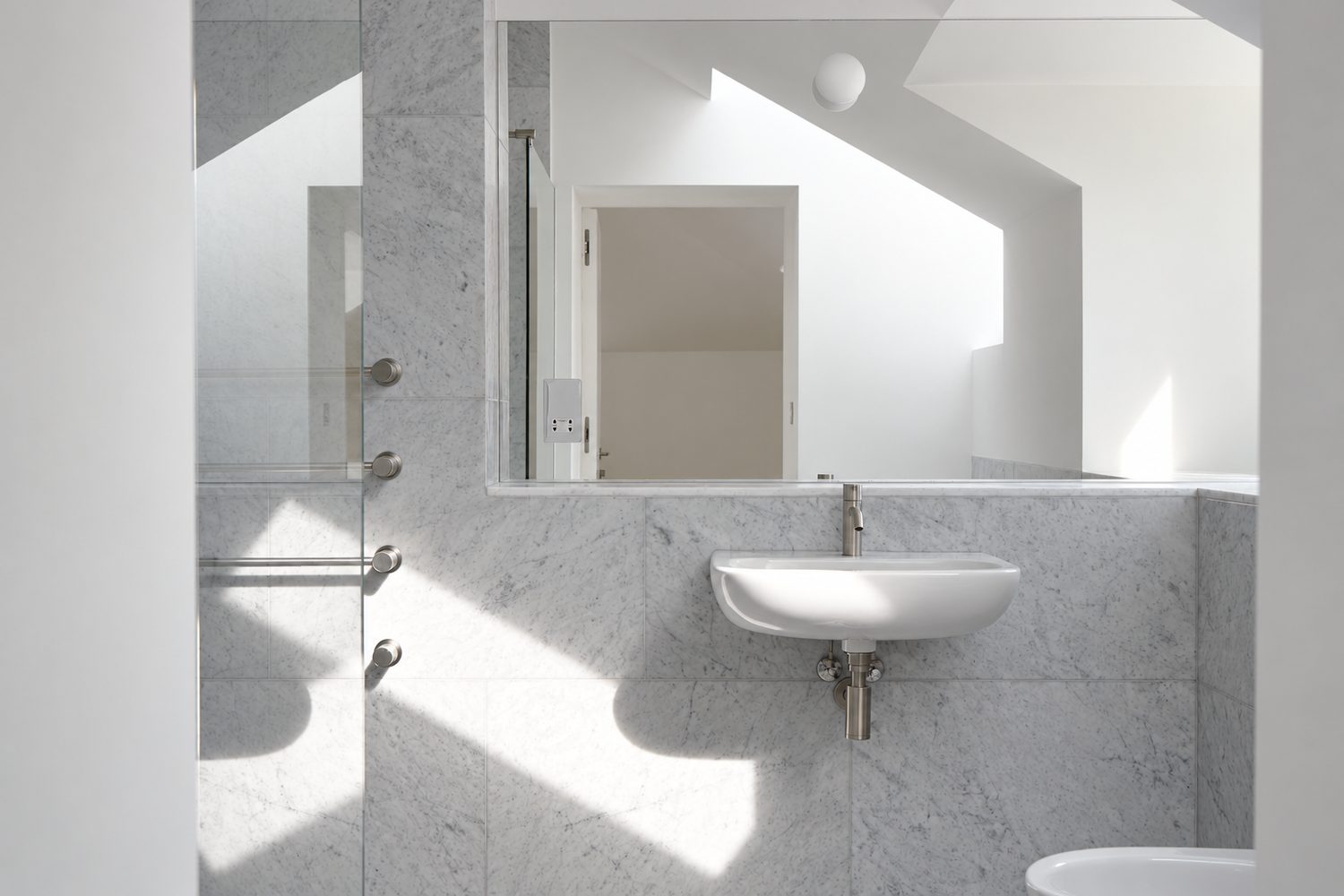 A wall-hung basin against a full-height Carrara marble wall, Oxford - Roma Marble