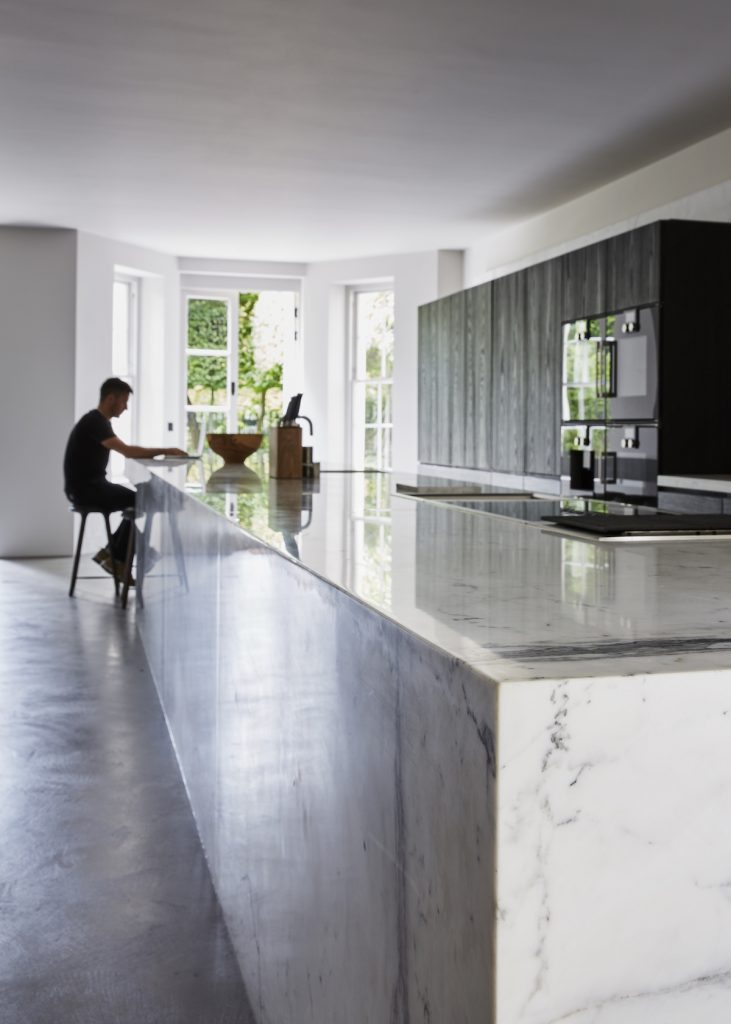 Statuario Venato, carried across each room to keep its grey veining running continuously — Randolf Road, Roma Marble