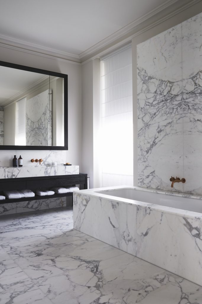 In the main bathroom the wall behind the bath is book-matched — Randolf Road, Roma Marble