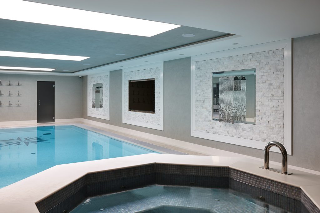 A Cappuccino marble border and skirting frames a Rene Beige limestone floor — Cloak House, Roma Marble